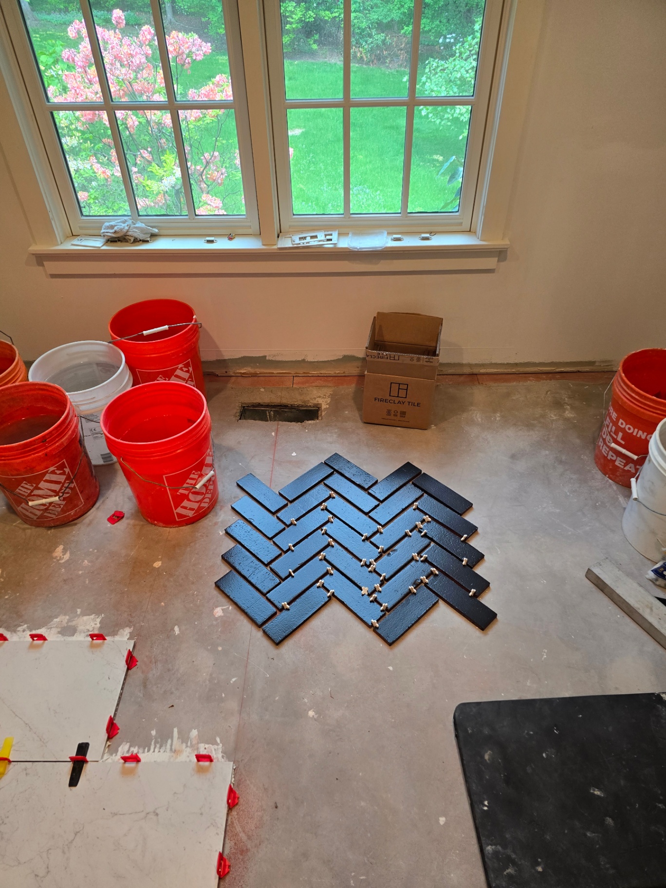 Custom herringbone tile floor layout in progress