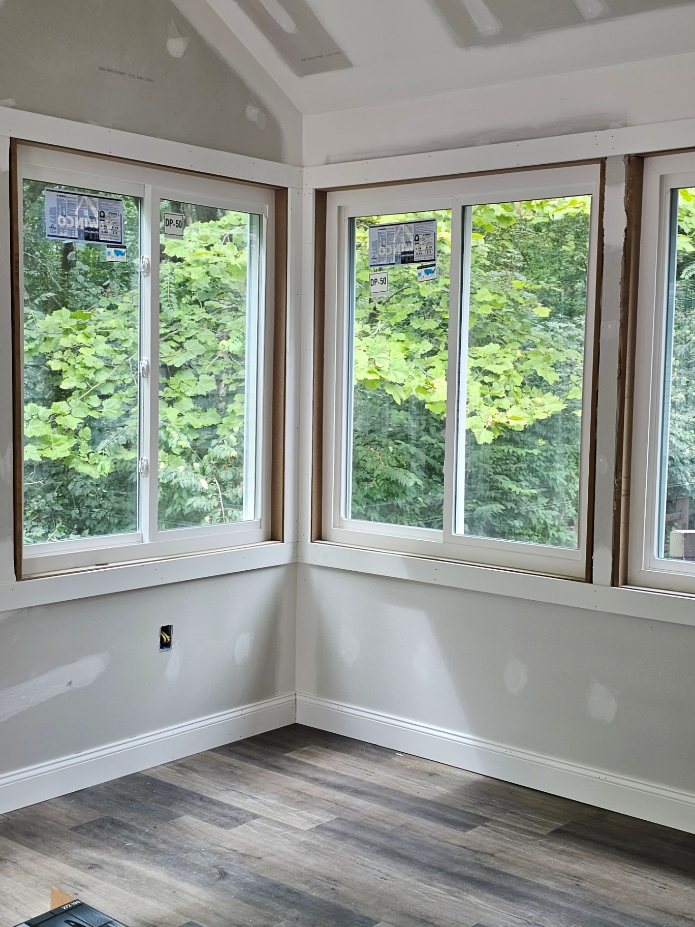 Sunroom corner windows with woodland view
