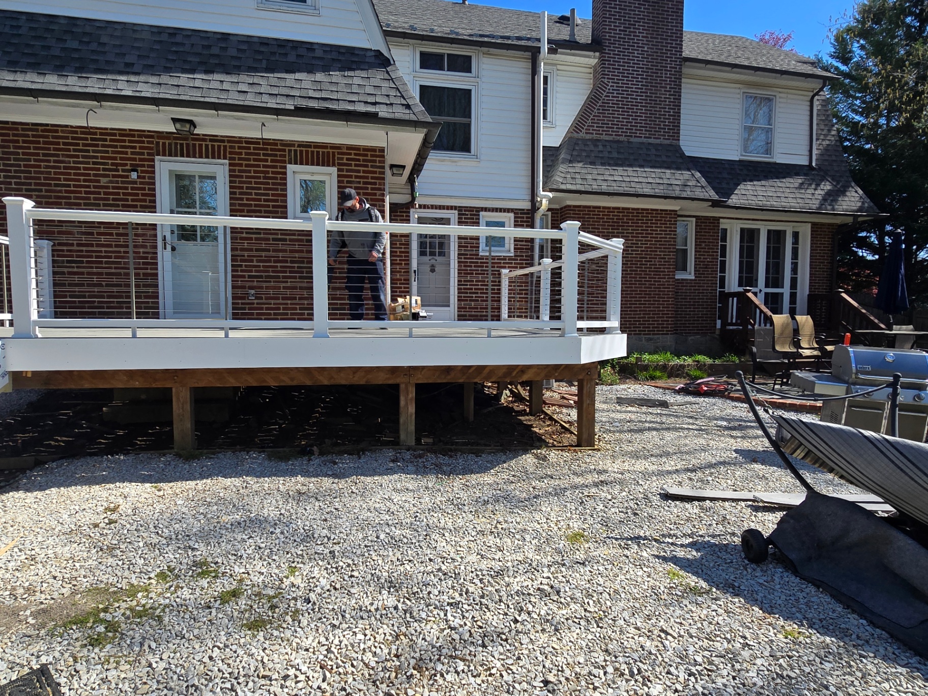 Finished elevated deck with white cable railing