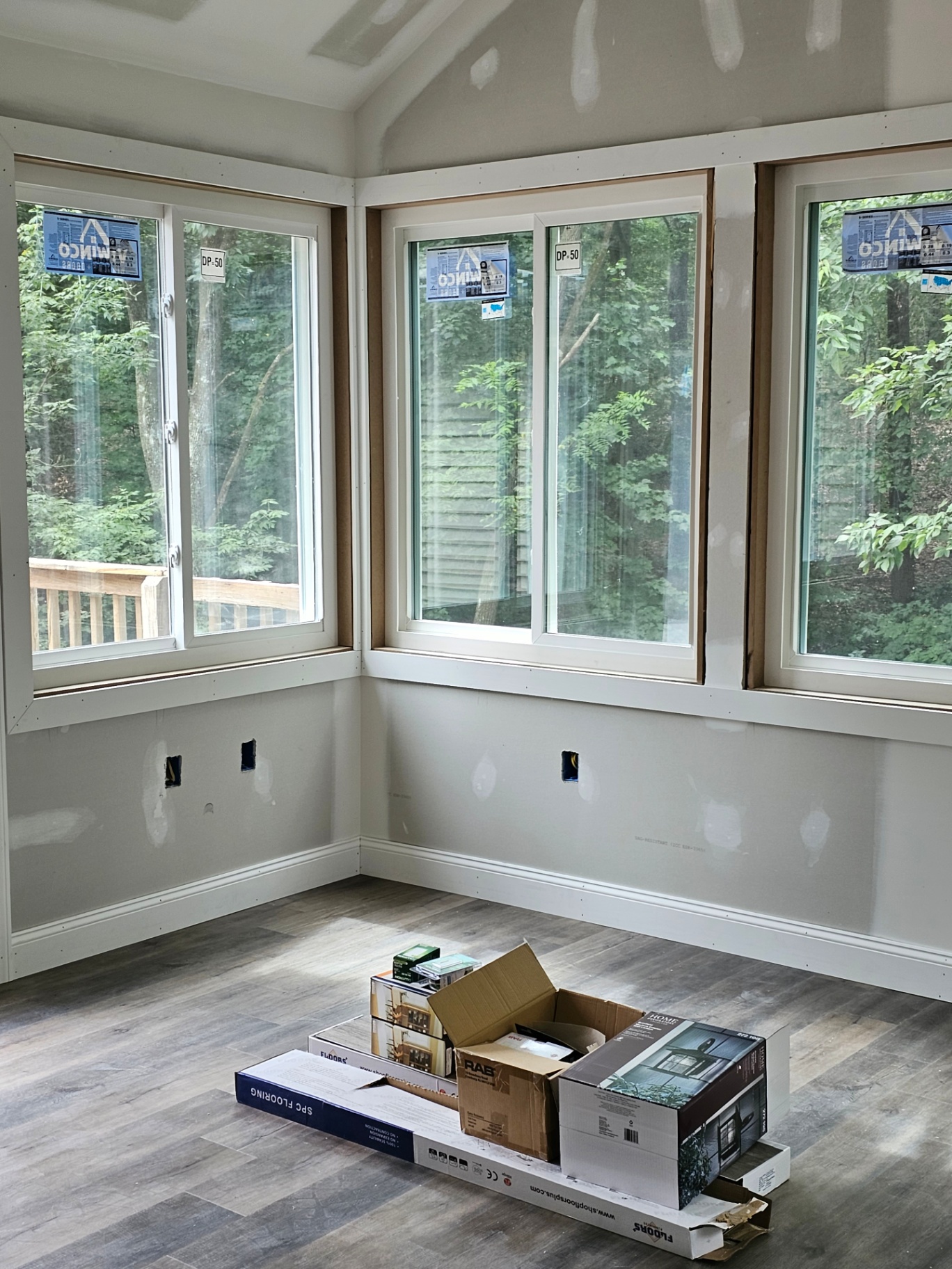 Sunroom with wraparound windows overlooking trees