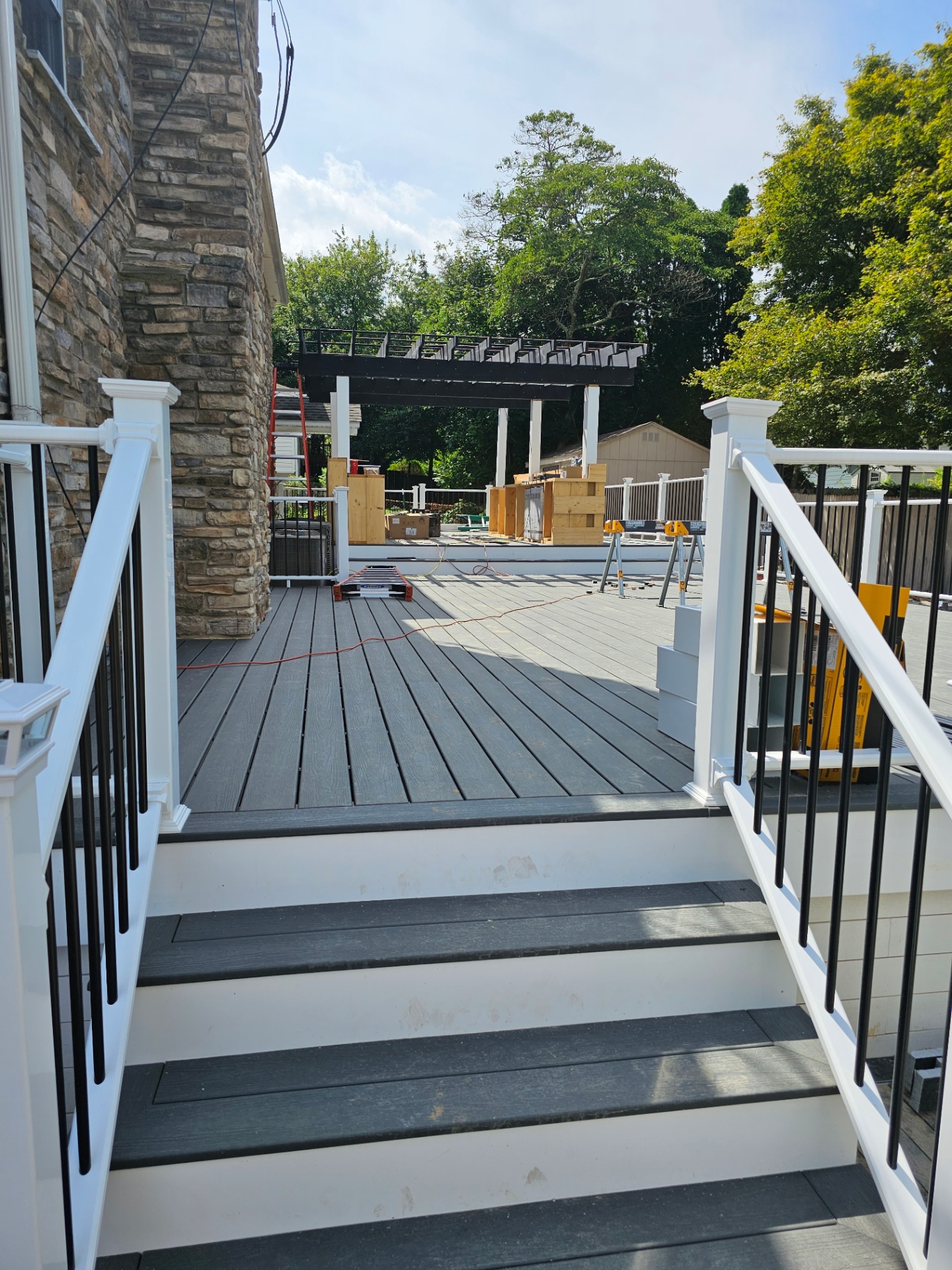 Gray composite steps with white posts and black balusters