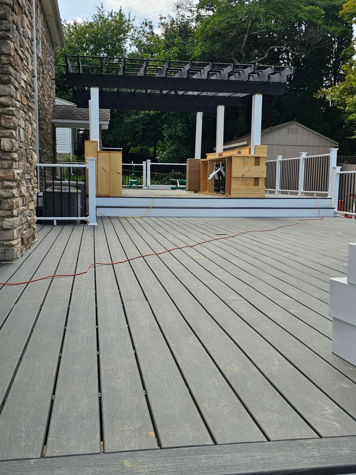 Wide gray composite deck with pergola