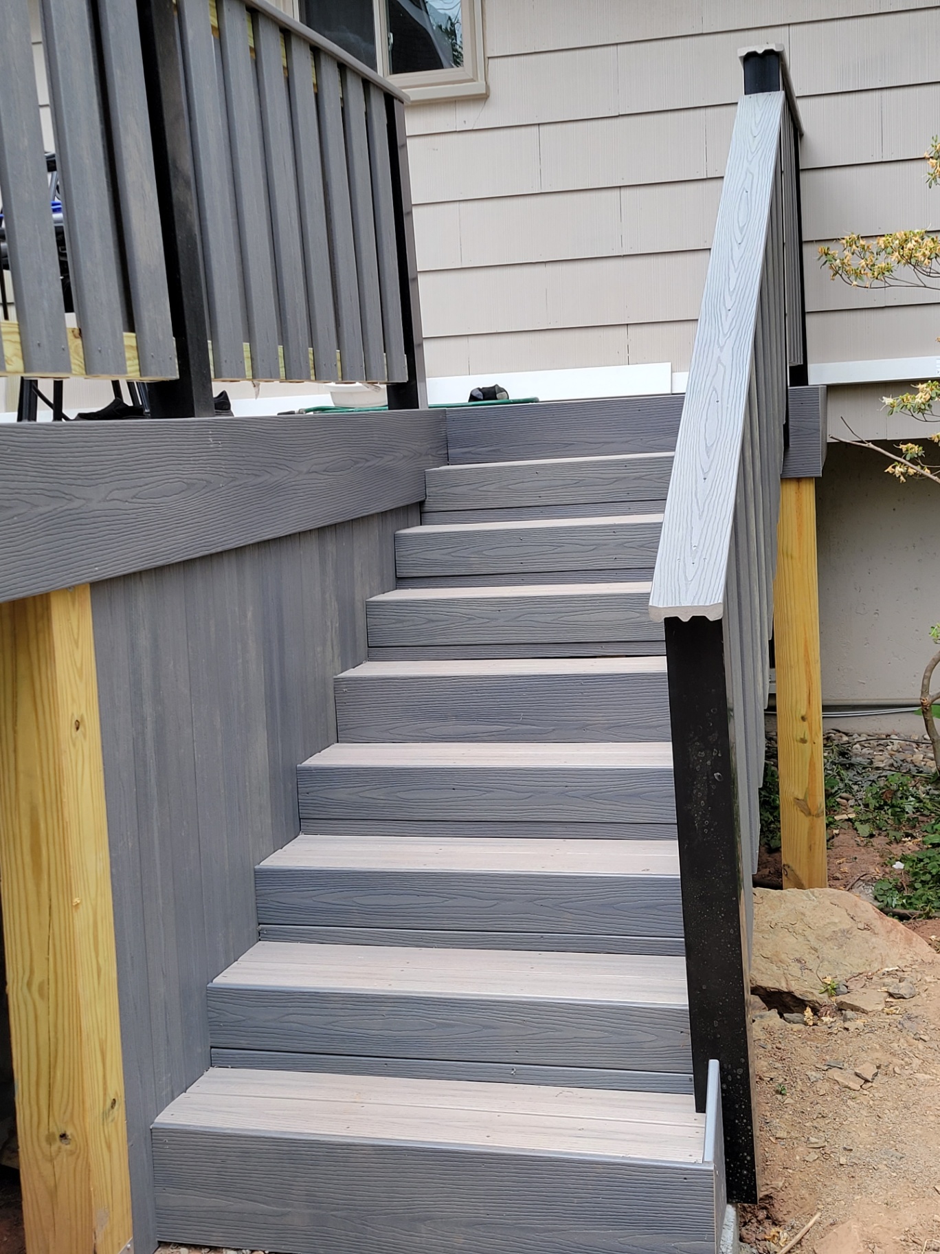 Gray composite stairs with black aluminum railing