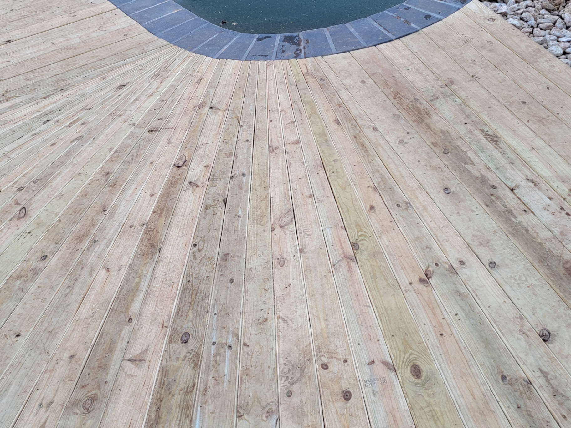 Sunburst board pattern detail around pool coping