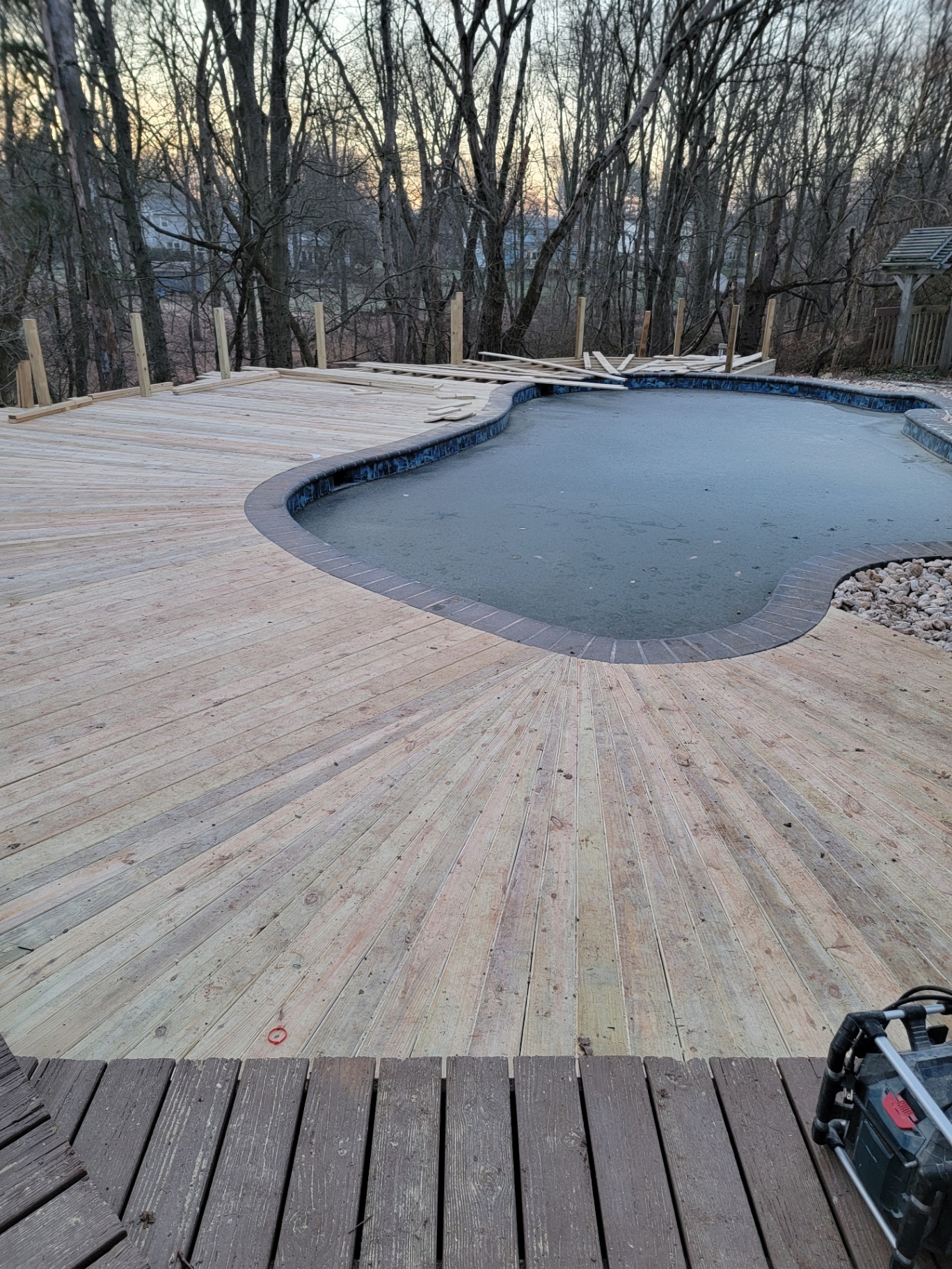 Pressure-treated pool deck planking with brick coping