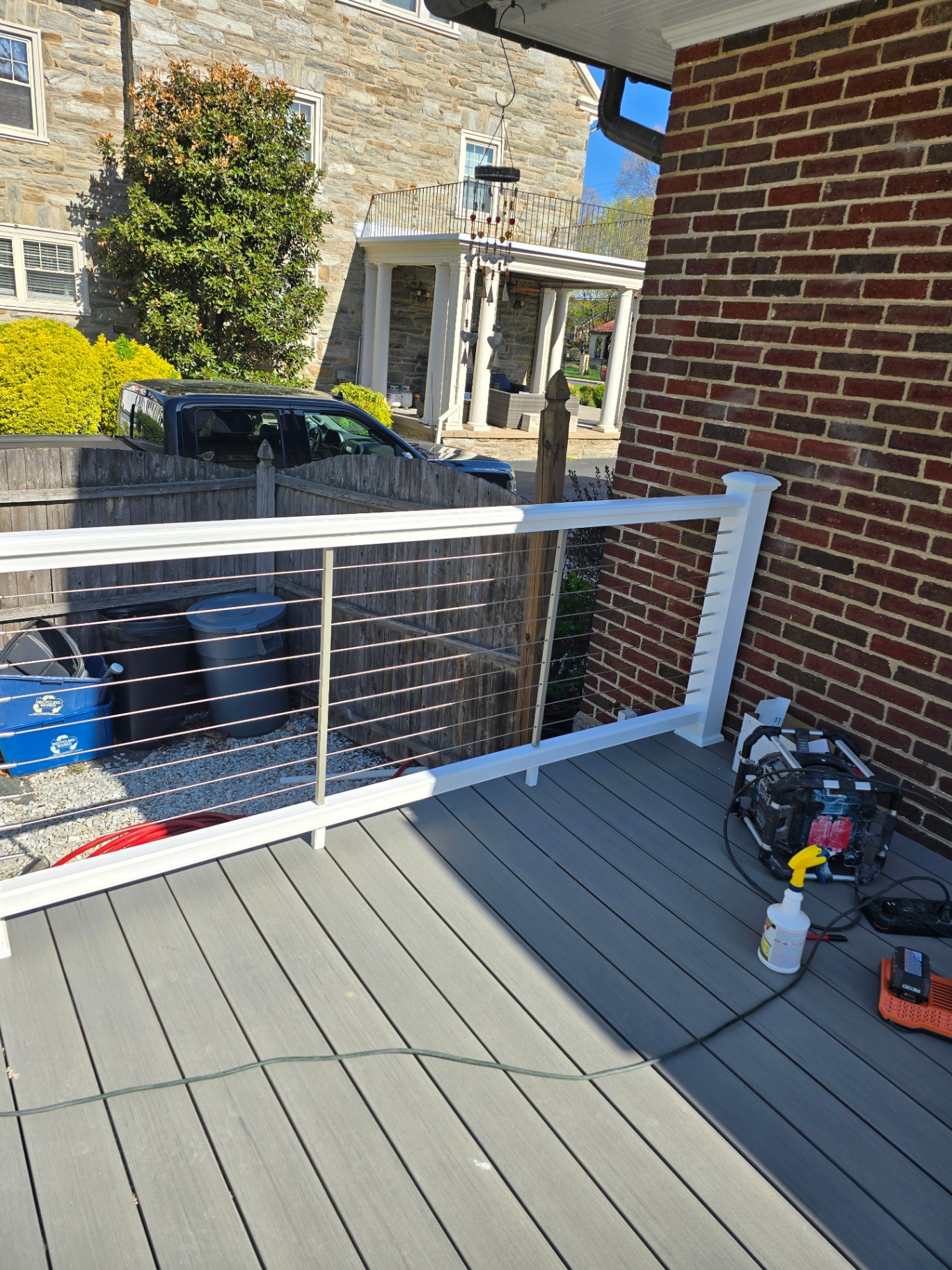 Cable railing overlooking gravel yard and stone home
