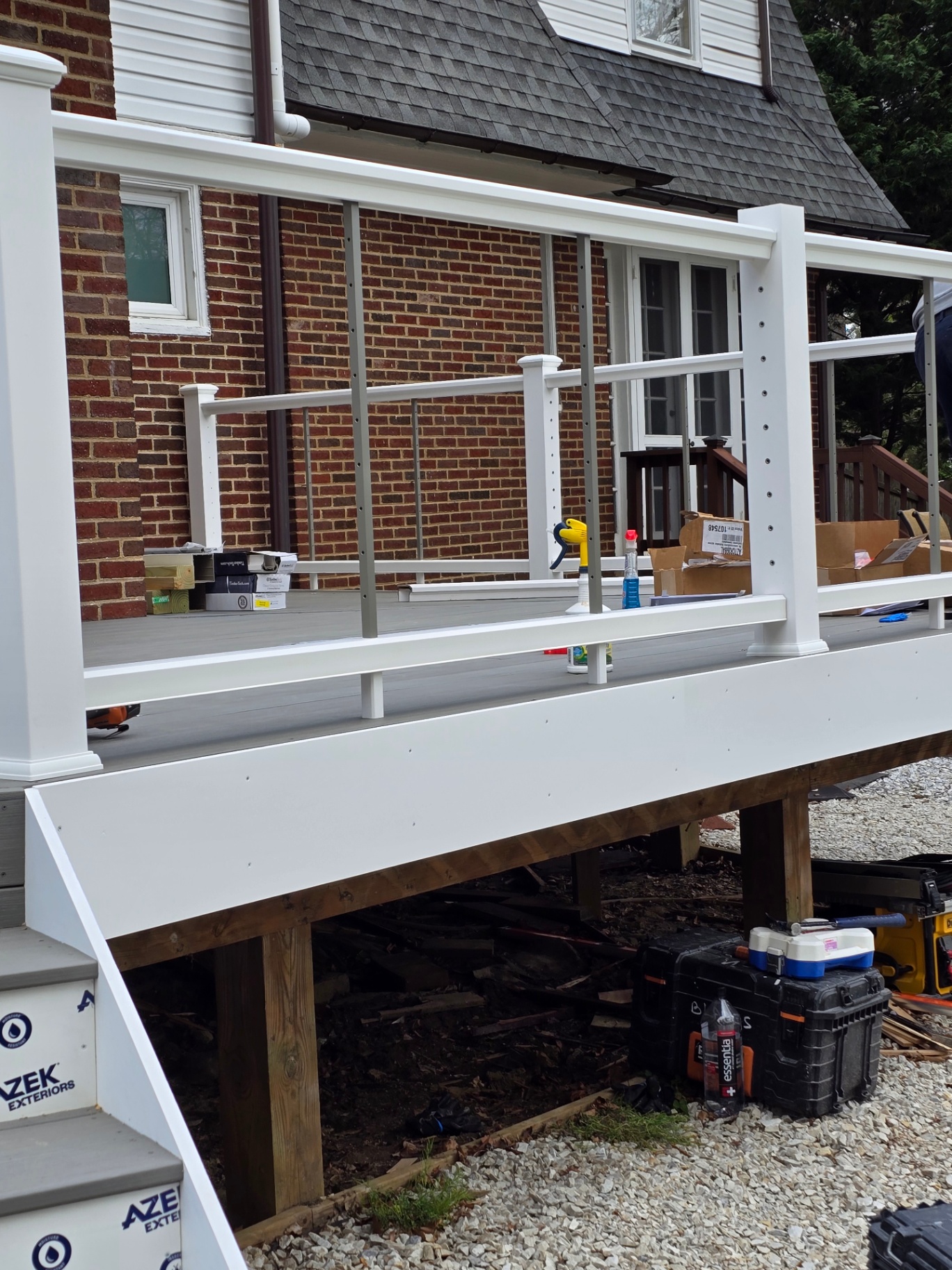 Cable railing system with white posts on composite deck