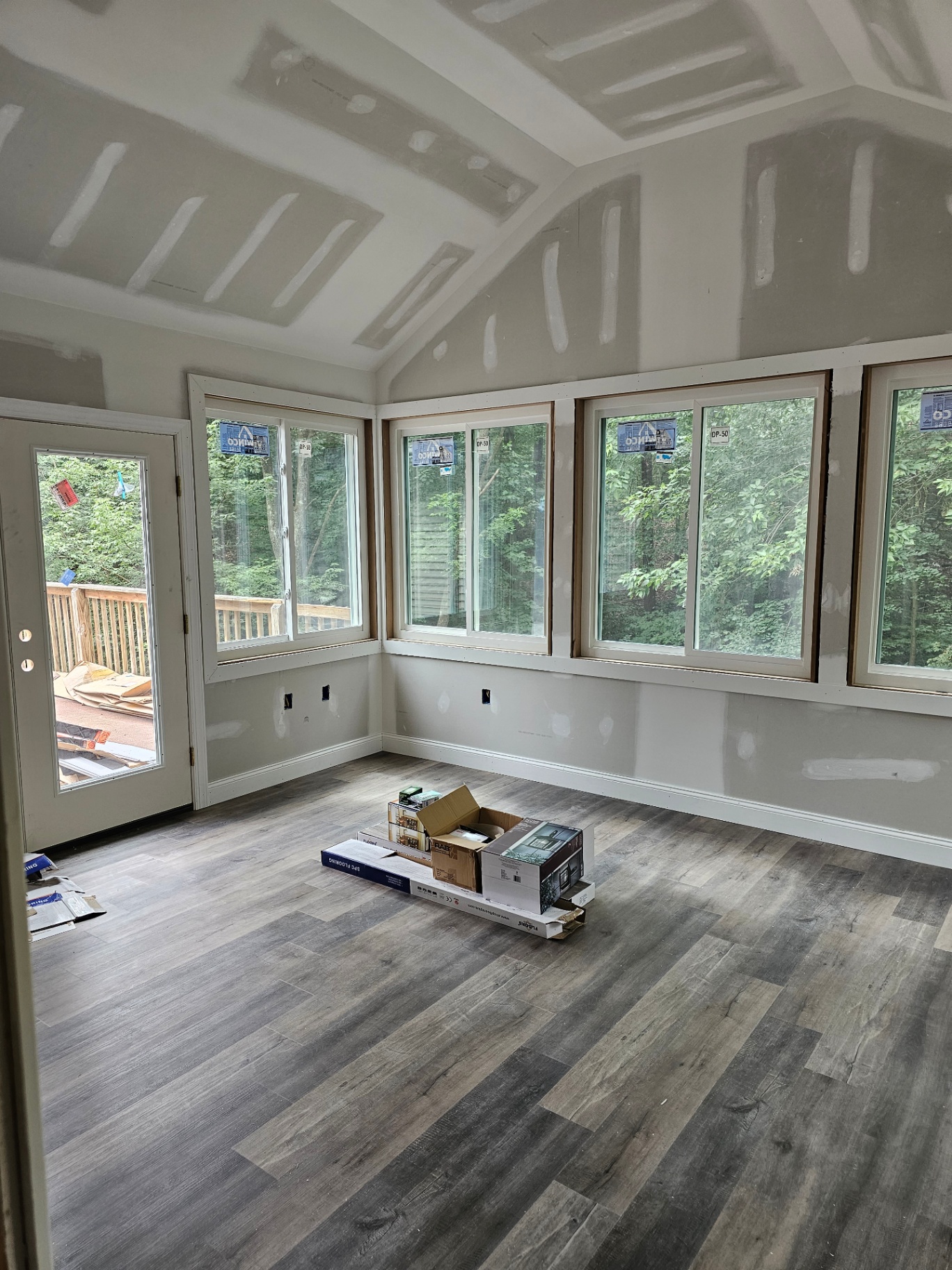 Finished sunroom with vaulted ceiling and large windows